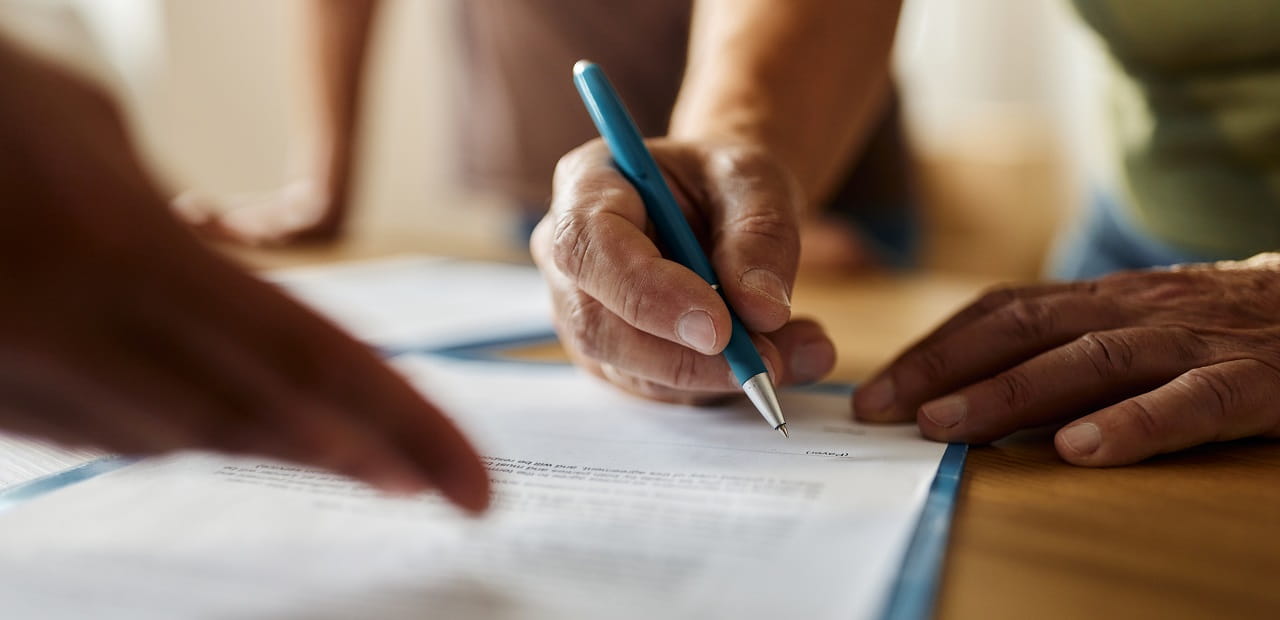 Person signing a document. 