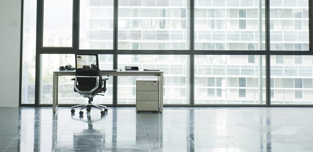 Empty chair and desk alone in an empty office. 